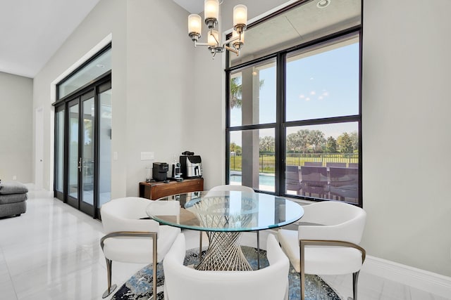 dining room featuring a chandelier, healthy amount of natural light, baseboards, and an office area