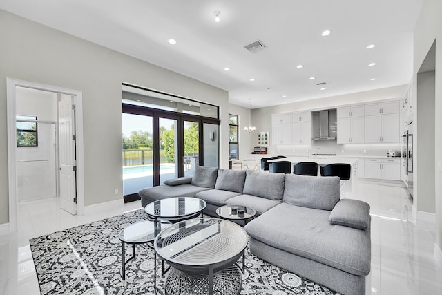 living area featuring plenty of natural light, recessed lighting, baseboards, and french doors