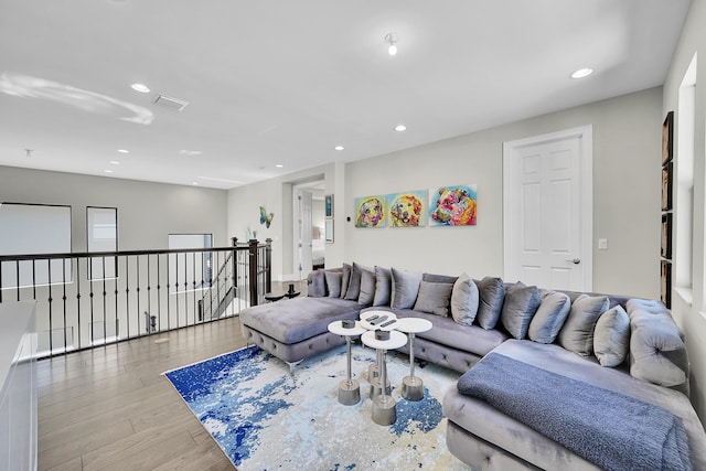 living room with wood finished floors and recessed lighting