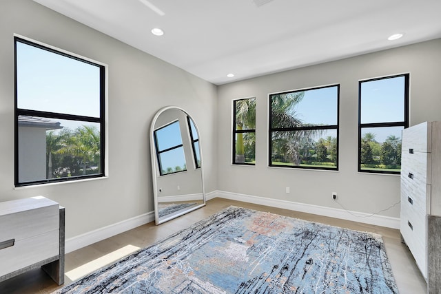 unfurnished bedroom featuring baseboards, recessed lighting, and light wood finished floors