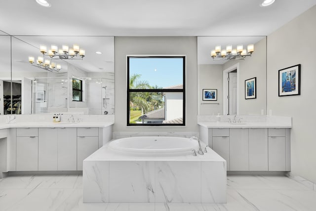 full bathroom with marble finish flooring, a shower stall, two vanities, and recessed lighting