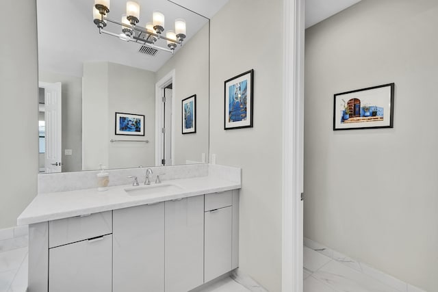 bathroom with marble look tiles, vanity, and baseboards