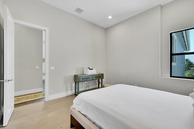 bedroom with light wood finished floors, recessed lighting, and baseboards