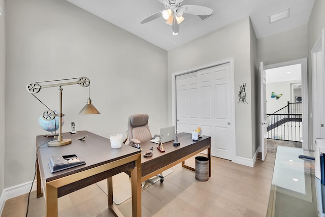 office space with ceiling fan, light wood-style floors, and baseboards