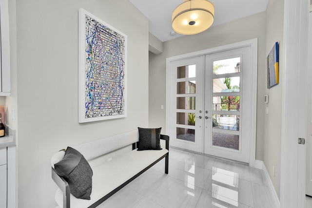 entryway with french doors, light tile patterned flooring, and baseboards