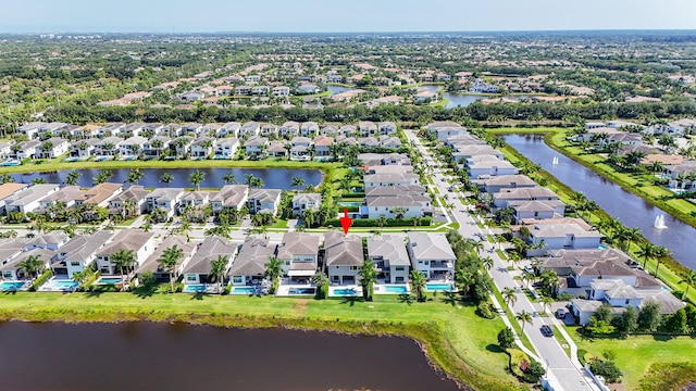 aerial view of residential area featuring a large body of water