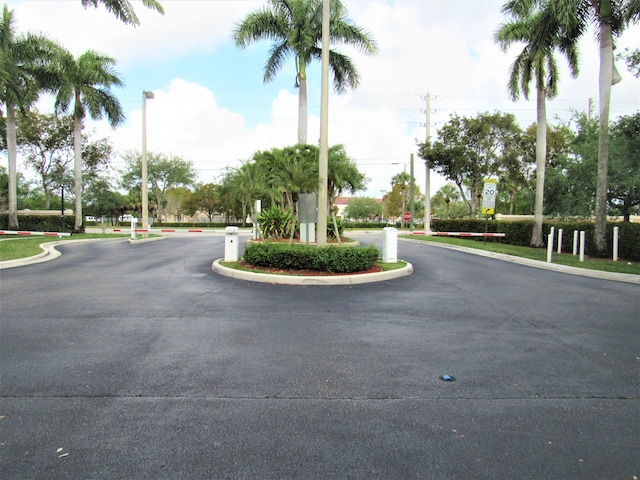 3810 N Jog Rd Unit 204, West Palm Beach, FL 33411 - view of asphalt street featuring traffic signs and curbs