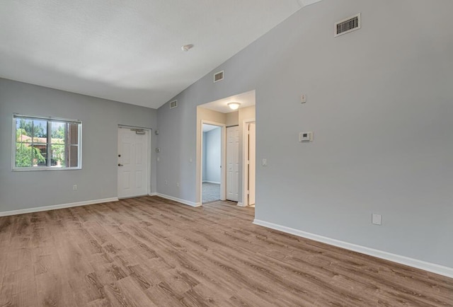 3810 N Jog Rd Unit 204, West Palm Beach, FL 33411 - empty room featuring light wood finished floors, baseboards, and high vaulted ceiling