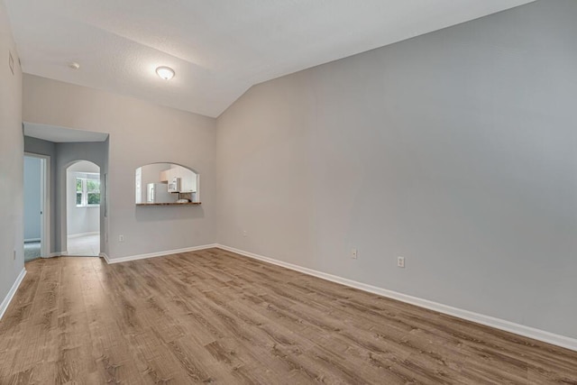 3810 N Jog Rd Unit 204, West Palm Beach, FL 33411 - unfurnished room with wood finished floors, baseboards, arched walkways, and vaulted ceiling