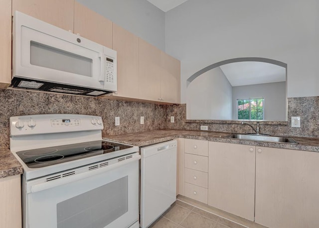 3810 N Jog Rd Unit 204, West Palm Beach, FL 33411 - kitchen with white appliances, a sink, backsplash, arched walkways, and light tile patterned flooring