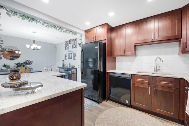 495 SE 8th St Unit 147, Deerfield Beach, FL 33441 - kitchen with black appliances, a sink, light wood-style flooring, tasteful backsplash, and light stone countertops