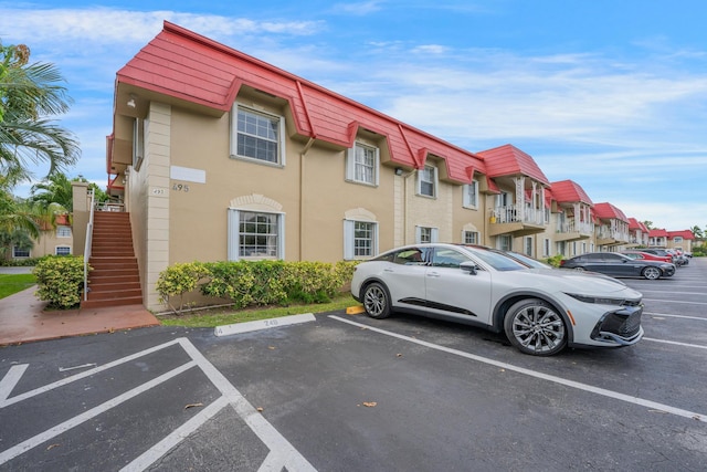 495 SE 8th St Unit 147, Deerfield Beach, FL 33441 - view of building exterior with uncovered parking and stairway