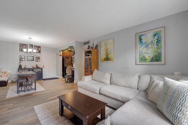 495 SE 8th St Unit 147, Deerfield Beach, FL 33441 - living area with light wood finished floors, a chandelier, and baseboards