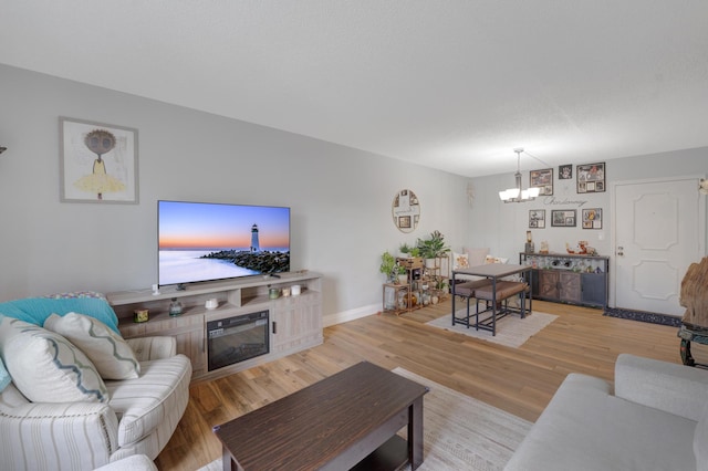 495 SE 8th St Unit 147, Deerfield Beach, FL 33441 - living area featuring a chandelier, light wood-style floors, and baseboards