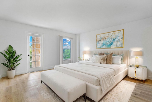 1111 S Ocean Blvd Unit 313, Boca Raton, FL 33432 - bedroom featuring light wood-style flooring, access to outside, and baseboards