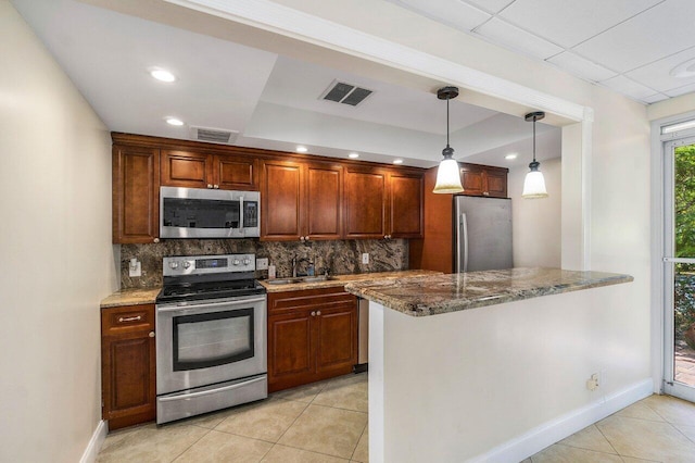 1111 S Ocean Blvd Unit 313, Boca Raton, FL 33432 - kitchen with appliances with stainless steel finishes, light tile patterned flooring, a sink, backsplash, and dark stone counters