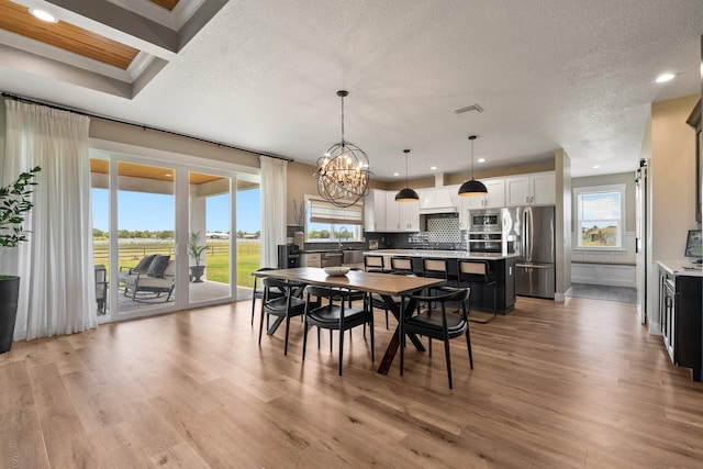 18102 Bridle Way, Port Saint Lucie, FL 34987 - dining space with recessed lighting, light wood-type flooring, a chandelier, and a textured ceiling