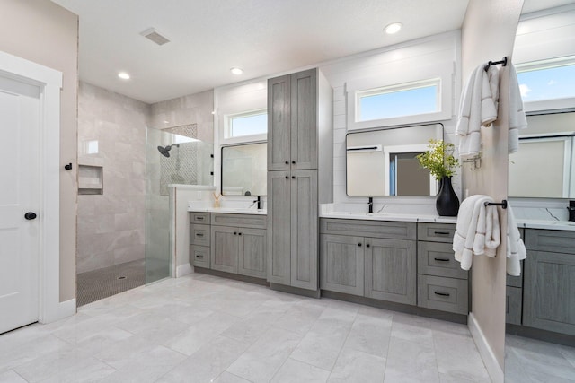 18102 Bridle Way, Port Saint Lucie, FL 34987 - full bath featuring walk in shower, two vanities, and recessed lighting