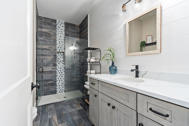 18102 Bridle Way, Port Saint Lucie, FL 34987 - full bathroom featuring a shower stall, vanity, toilet, and a textured ceiling