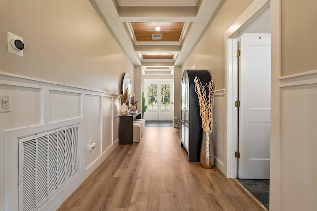 18102 Bridle Way, Port Saint Lucie, FL 34987 - hall featuring light wood-type flooring, a decorative wall, french doors, a wainscoted wall, and ornamental molding