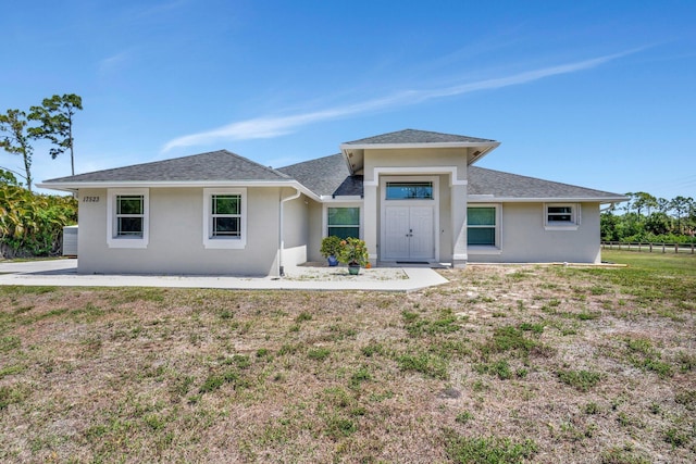 17523 89th Pl N, Loxahatchee, FL 33470 - view of front of home featuring stucco siding and a shingled roof