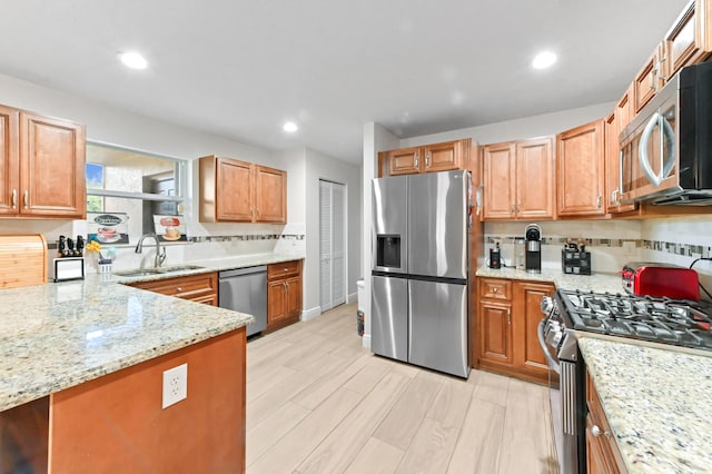 1184 Landings Run, Greenacres, FL 33413 - kitchen featuring appliances with stainless steel finishes, a sink, light stone counters, light wood finished floors, and recessed lighting