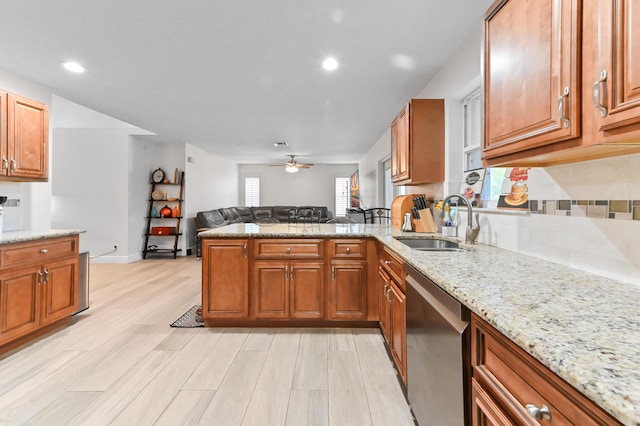 1184 Landings Run, Greenacres, FL 33413 - kitchen featuring stainless steel dishwasher, a sink, a peninsula, open floor plan, and a ceiling fan