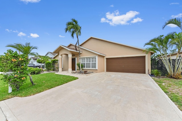 1184 Landings Run, Greenacres, FL 33413 - view of front of property with stucco siding, an attached garage, and driveway
