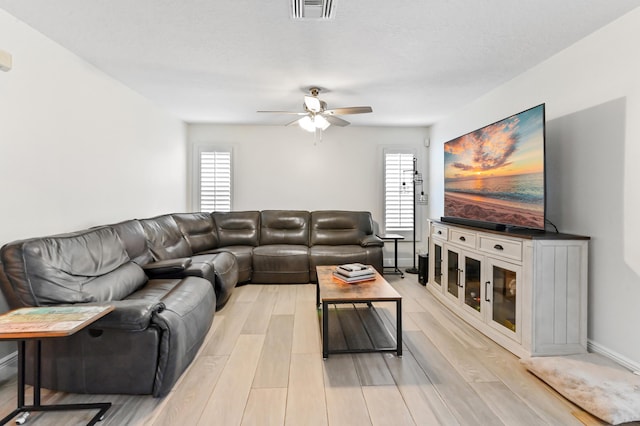 1184 Landings Run, Greenacres, FL 33413 - living room featuring a ceiling fan, light wood finished floors, healthy amount of natural light, and baseboards