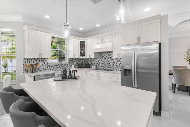 2371 Simonson Dr, Wellington, FL 33414 - kitchen with stainless steel appliances, custom range hood, white cabinets, decorative backsplash, and light stone counters