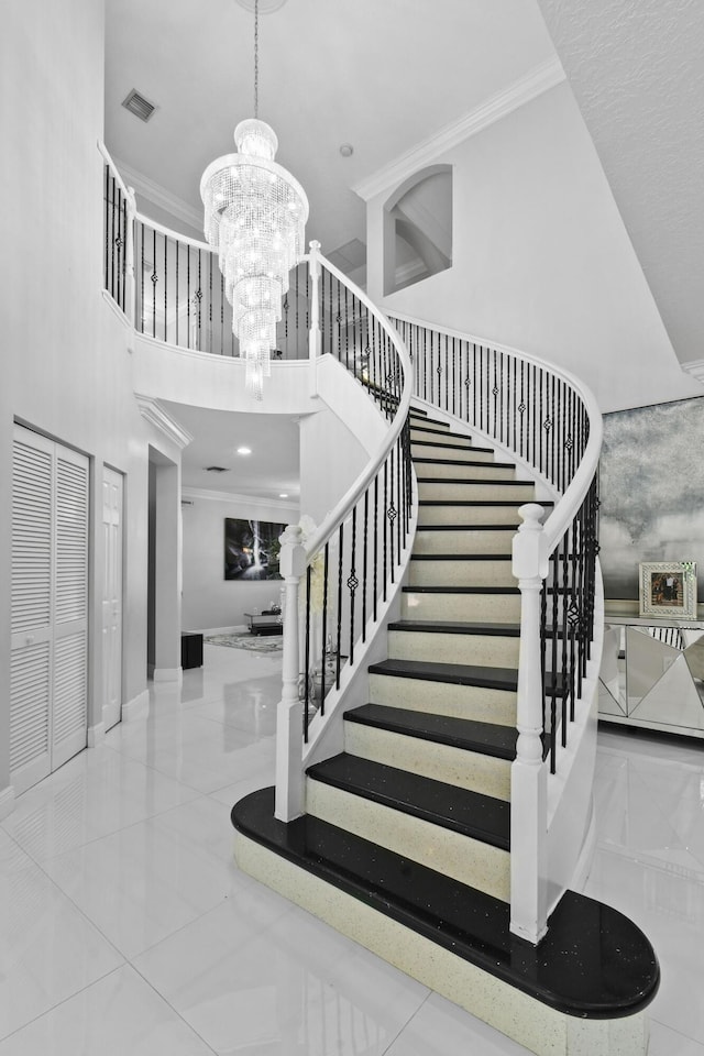 2371 Simonson Dr, Wellington, FL 33414 - staircase with a chandelier, ornamental molding, baseboards, a high ceiling, and marble finish flooring