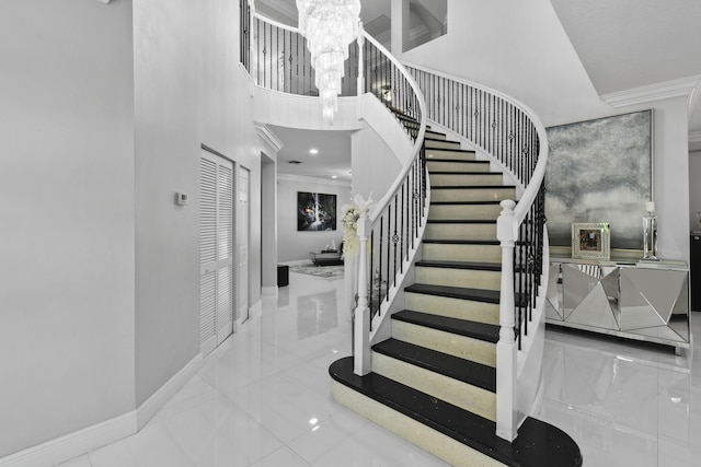 2371 Simonson Dr, Wellington, FL 33414 - stairs with a chandelier, crown molding, baseboards, and a high ceiling