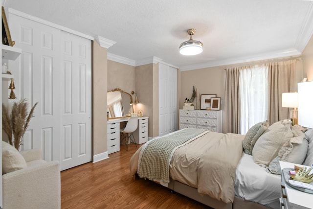 2371 Simonson Dr, Wellington, FL 33414 - bedroom with crown molding, two closets, an office area, and wood finished floors