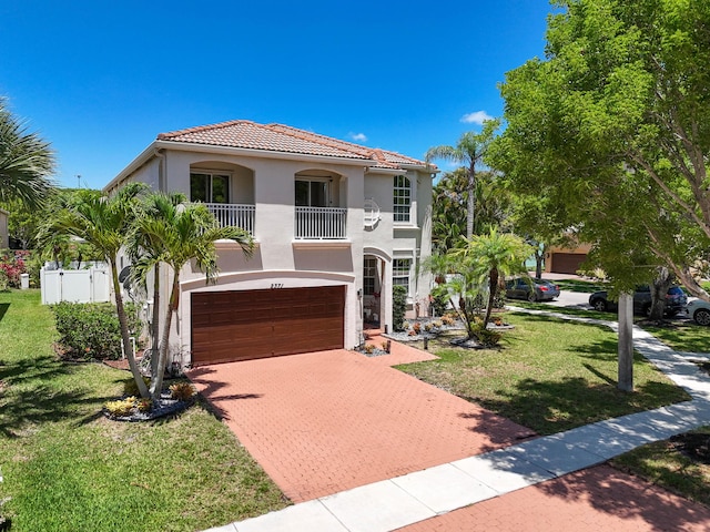 2371 Simonson Dr, Wellington, FL 33414 - mediterranean / spanish-style home with a balcony, decorative driveway, stucco siding, an attached garage, and a front yard