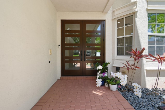2371 Simonson Dr, Wellington, FL 33414 - view of exterior entry featuring french doors and stucco siding