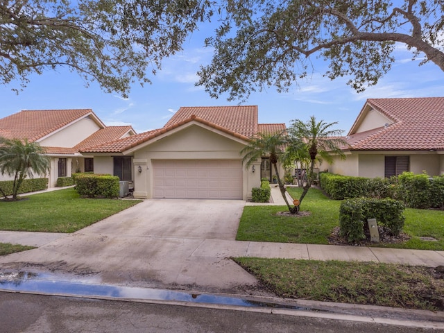 2855 Eagle Ln, West Palm Beach, FL 33409 - view of front of house with stucco siding, a garage, a front lawn, and a tile roof