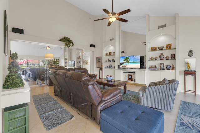 2855 Eagle Ln, West Palm Beach, FL 33409 - living room featuring ceiling fan, high vaulted ceiling, light tile patterned flooring, and built in shelves