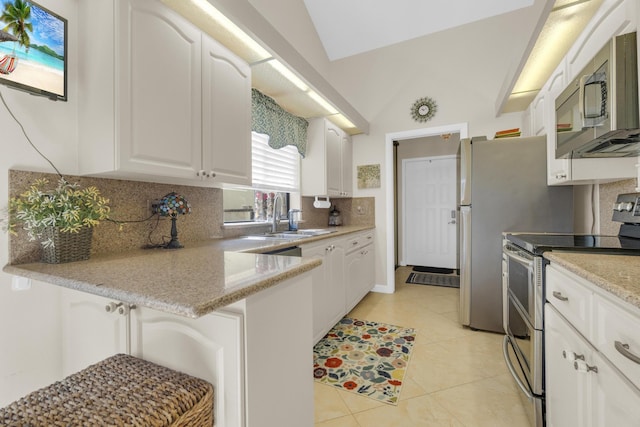 2855 Eagle Ln, West Palm Beach, FL 33409 - kitchen with appliances with stainless steel finishes, a sink, white cabinetry, backsplash, and light tile patterned floors