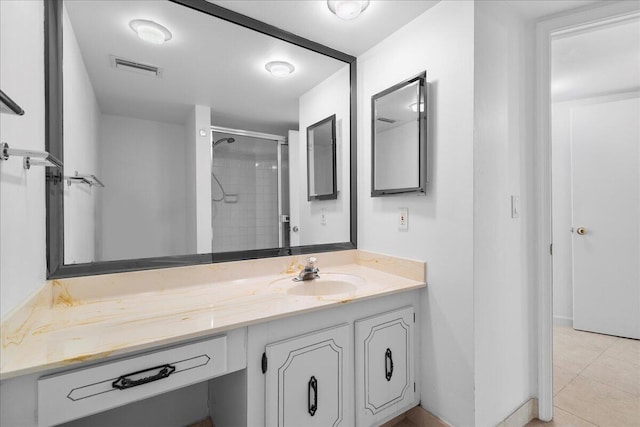 2800 N Ocean Dr Unit B-24D, Singer Island, FL 33404 - bathroom with tiled shower, vanity, and tile patterned floors