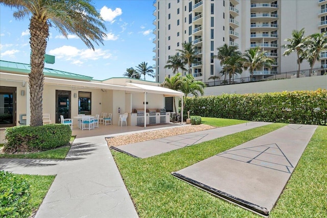 2800 N Ocean Dr Unit B-24D, Singer Island, FL 33404 - view of home's community featuring a patio and a lawn