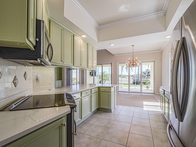 5151 Formosa Cir, Vero Beach, FL 32967 - kitchen with stainless steel appliances, green cabinetry, a peninsula, backsplash, and a chandelier