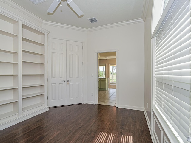 5151 Formosa Cir, Vero Beach, FL 32967 - unfurnished bedroom featuring crown molding, dark wood-type flooring, baseboards, ceiling fan, and a closet