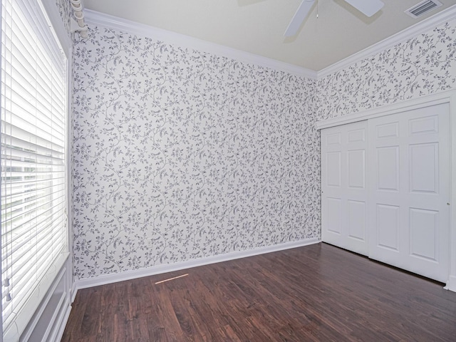 5151 Formosa Cir, Vero Beach, FL 32967 - unfurnished bedroom with wallpapered walls, ornamental molding, dark wood finished floors, ceiling fan, and baseboards