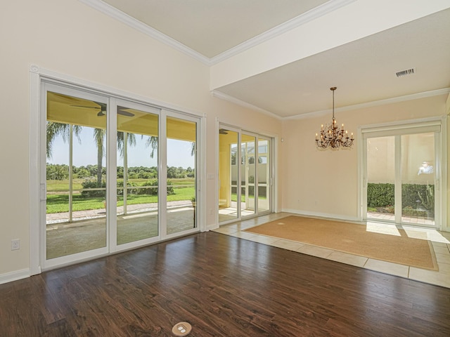 5151 Formosa Cir, Vero Beach, FL 32967 - unfurnished room with a chandelier, baseboards, dark wood-type flooring, and ornamental molding