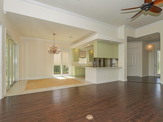 5151 Formosa Cir, Vero Beach, FL 32967 - unfurnished living room with wood finished floors, healthy amount of natural light, crown molding, a chandelier, and ceiling fan