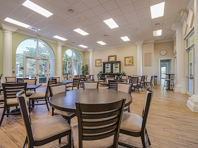 5151 Formosa Cir, Vero Beach, FL 32967 - dining room featuring ornate columns, healthy amount of natural light, light wood finished floors, french doors, and crown molding