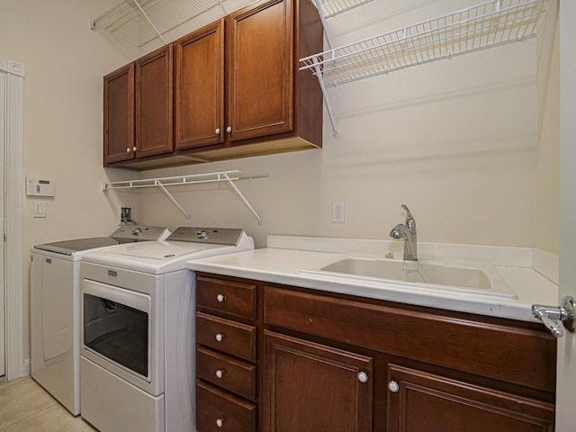 5151 Formosa Cir, Vero Beach, FL 32967 - laundry area featuring cabinet space, washer and clothes dryer, and light tile patterned floors