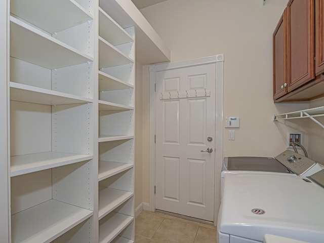 5151 Formosa Cir, Vero Beach, FL 32967 - laundry area with cabinet space, light tile patterned flooring, and separate washer and dryer