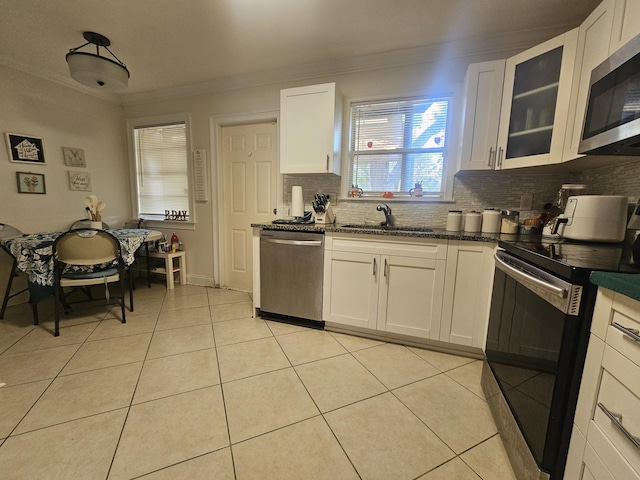 2018 S 10th St Unit C, Fort Pierce, FL 34950 - kitchen featuring stainless steel appliances, a sink, decorative backsplash, ornamental molding, and light tile patterned flooring