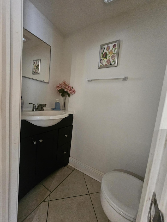 2018 S 10th St Unit C, Fort Pierce, FL 34950 - bathroom featuring vanity, toilet, tile patterned flooring, and baseboards